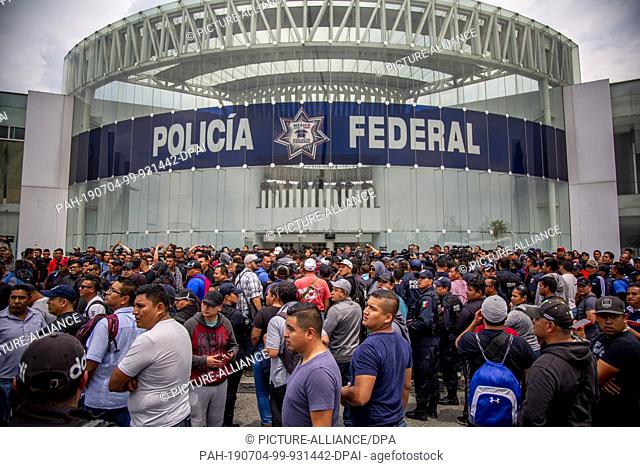 03 July 2019, Mexico, Mexiko-Stadt: Numerous police protest in front of the police headquarters in the district of Iztapalapa against the plan to admit them to...