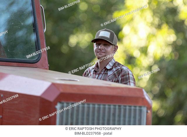 Portrait of Caucasian man near tractor