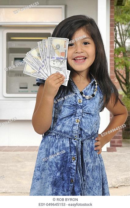Little girl holding a handfull of cash money