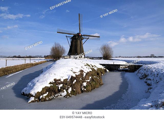 Windmill Oude Doornse Molen in a snow covered landscape near Almkerk in the Dutch province Noord-Brabant