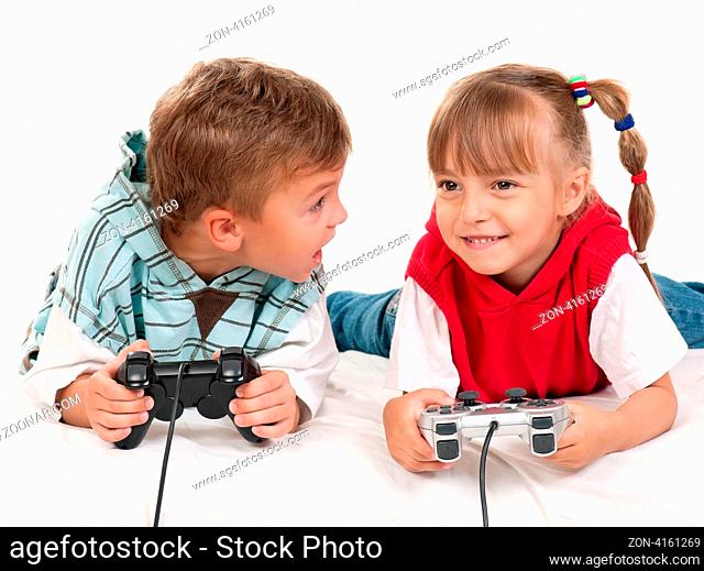 Happy children - girl and boy playing a video game