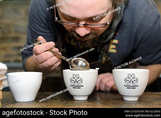 03 March 2021, Saxony-Anhalt, Aschersleben: Co-owner Dominik Rider tests the aroma of a new coffee blend. The ""Kaffeemänner Rösterei"" produces individual...