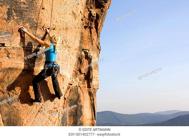 Young woman climbing