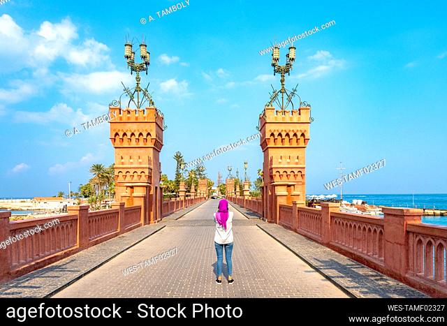 Egypt, Alexandria, Rear view of woman standing on Montaza bridge