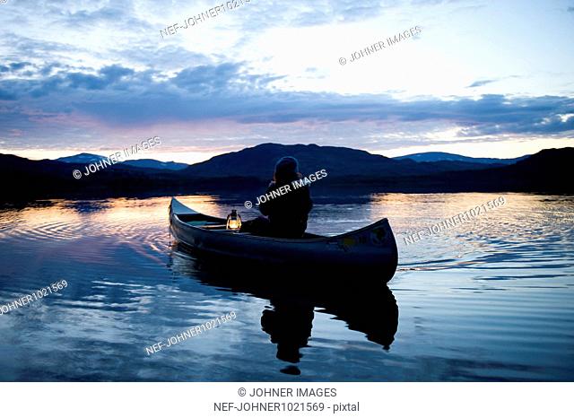 Person in boat with lantern