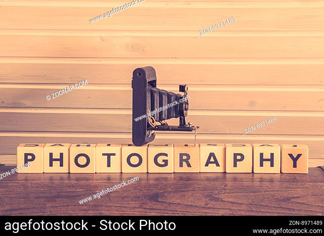 Vintage camera on a photography sign with wooden cubes