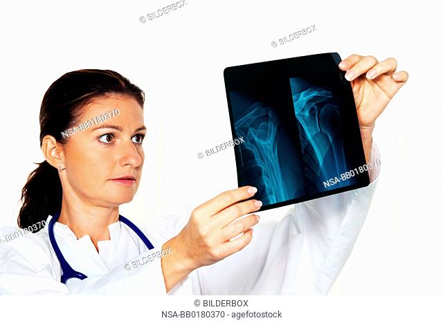 Young doctor in her doctor's office with an x-ray