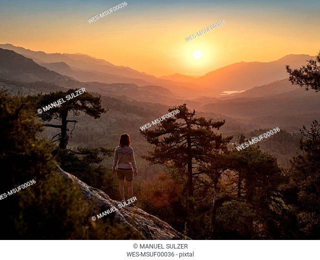 Female hiker standing on viewpoint, Albertacce, Lac de Calacuccia at sunrise, Haute-Corse, Corsica, France