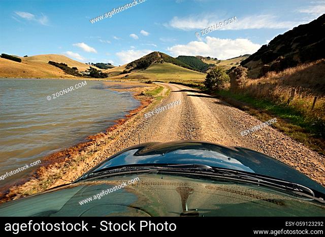 Driving on a dirt road in the hills in New Zealand