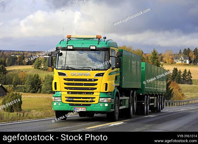 Yellow and green Scania R500 truck of Siuntion Koneasema Oy in seasonal sugar beet haul on scenic autumnal road in Salo, Finland. October 12, 2019