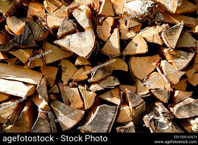 Pile of birch firewood on a sunny summer day