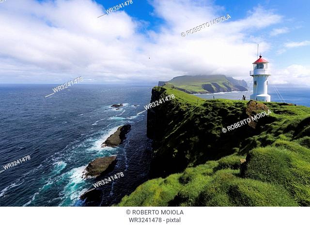 Lighthouse on islet known as Mykines Holmur, Mykines Island, Faroe Islands, Denmark, Europe