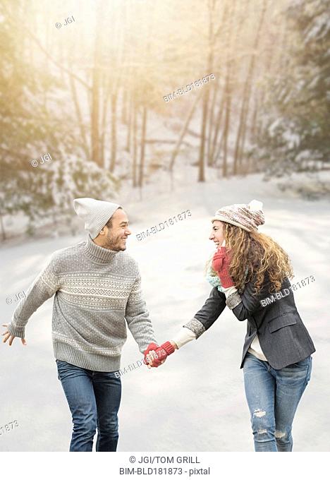 Couple holding hands in snow