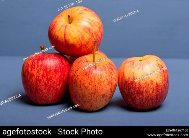 apples on a blue wooden table, studio picture
