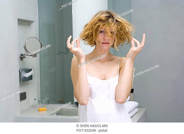 Woman looking worried in bathroom