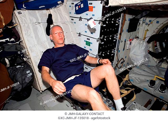 Astronaut Patrick Forrester, STS-117 mission specialist, exercises on a bicycle ergometer on the middeck of the Space Shuttle Atlantis
