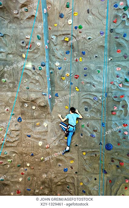 Boy scaling an indoor rock climbing wall  Atlanta, Georgia