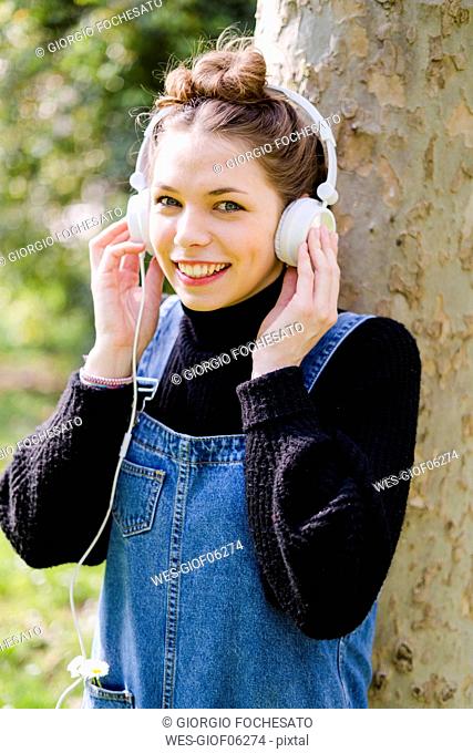 Young woman with headphones in a park