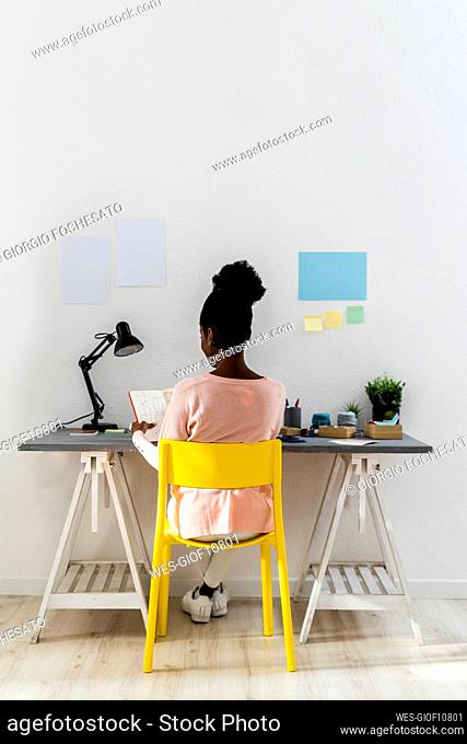 Young businesswoman working while sitting at home office