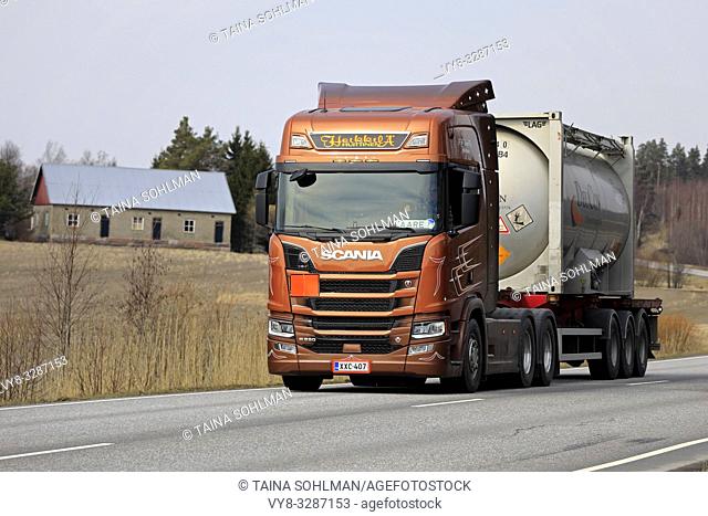 Salo, Finland - April 5, 2019: Bronze Next Generation Scania R580 truck of AH Trans Oy hauls chemical liquid container along highway in Finland