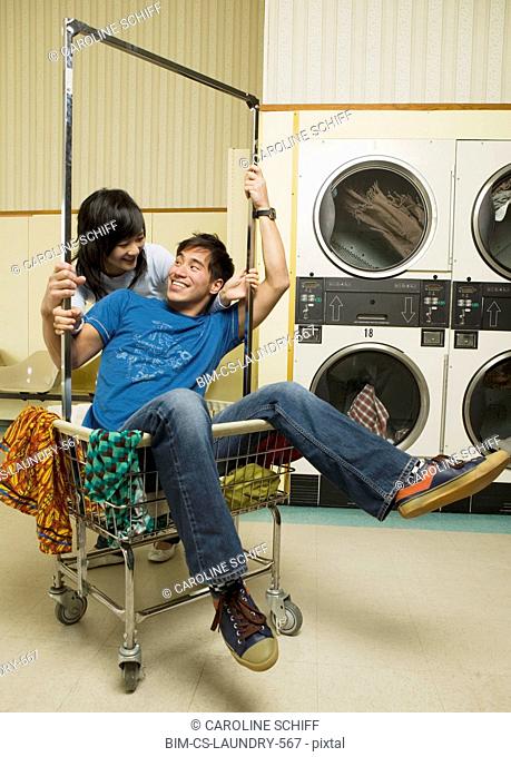 Asian couple in Laundromat
