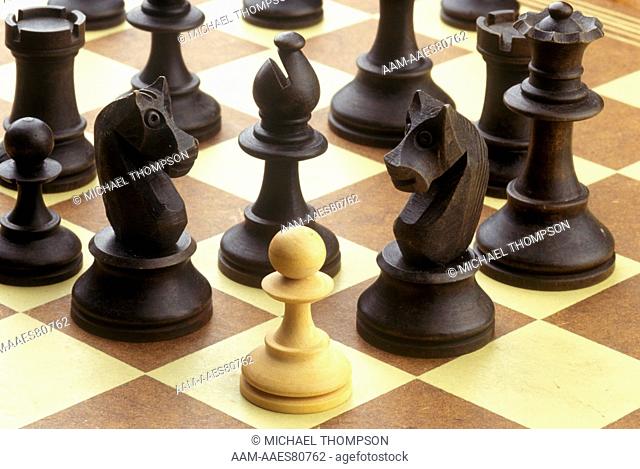 Dangerous Odds - White Pawn faces heavy odds as Black Chessman gather for attack