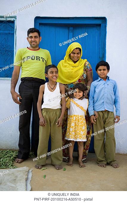 Family standing in the courtyard of a house, Farrukh Nagar, Gurgaon, Haryana, India