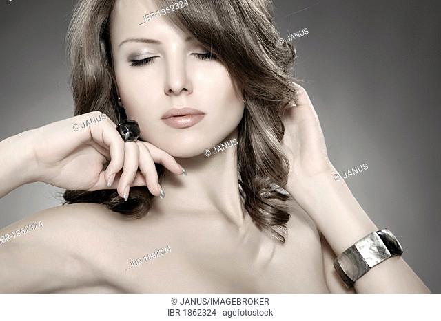 Young woman wearing a ring and a bracelet, beauty shot, portrait