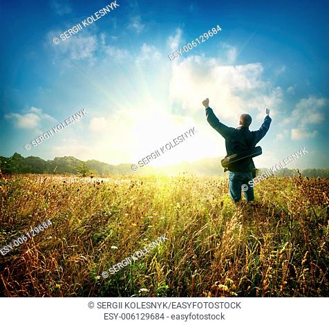 Man in the field at sunrise in autumn