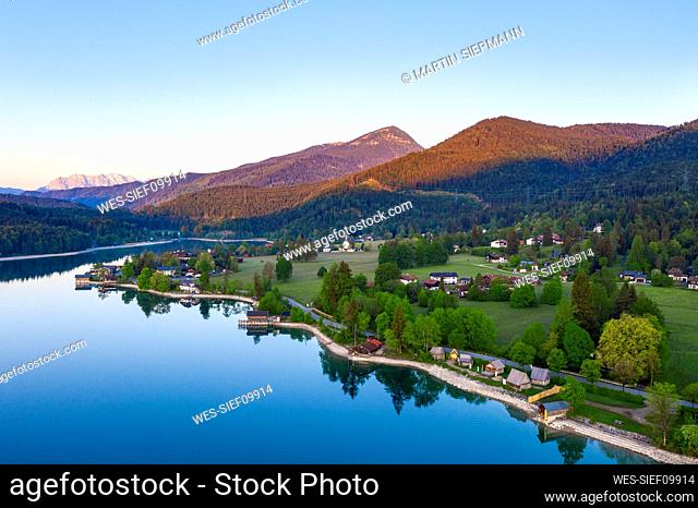 Germany, Bavaria, Kochel am See, Drone view of village on shore of Lake Walchen at springtime dawn