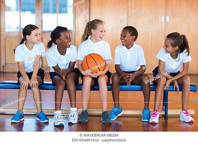 School kids having fun in basketball court