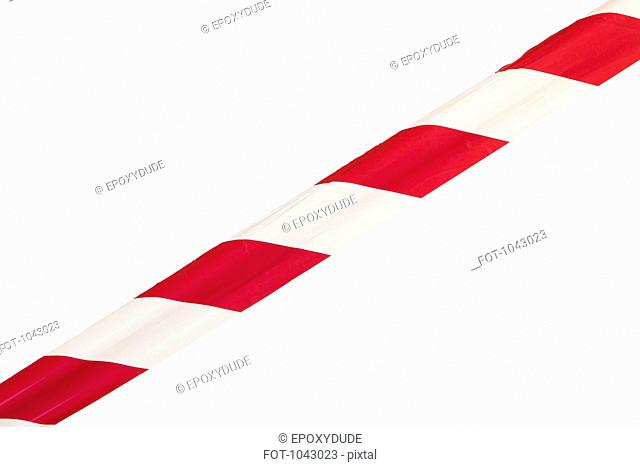 A single strip of red and white striped cordon tape