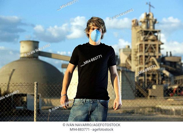 Man with a contamination mask near a cement works