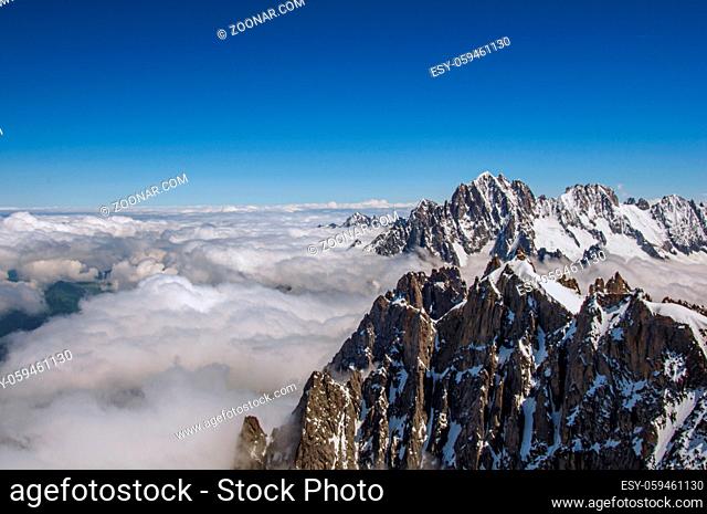 Snowy peaks and mountains in a sunny day, viewed from the Aiguille du Midi, near Chamonix. A famous ski resort located in Haute-Savoie Province