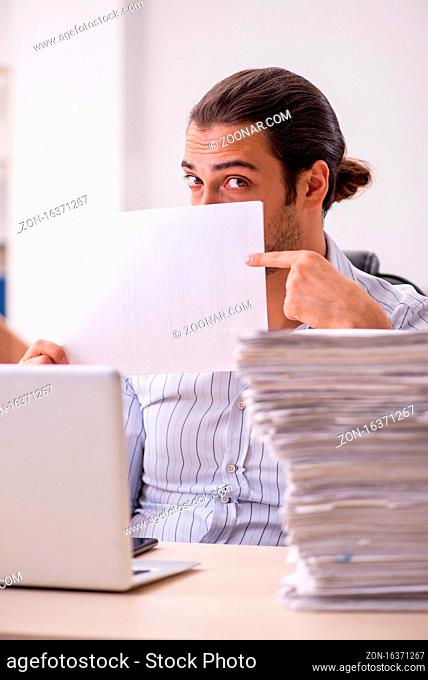 Young employee holding blank in the office