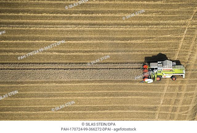 Farmers drive down grain fields with a combine harvester near Salzgitter, Germany, 19 July 2017.....(Aerial View taken with an ultralight aircraft) Photo: Silas...