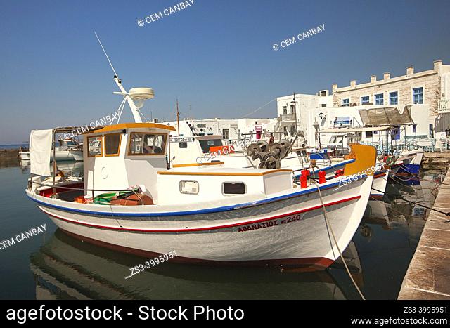 Traditional fishing boats in front of the whitewashed houses in Naoussa port, Paros, Cyclades Islands, Greek Islands, Greece, Europe