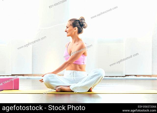 Fit yoga instructor showing poses in her class