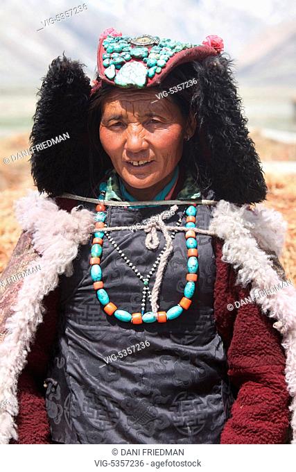INDIA, RANGDUM, 27.06.2014, Ladakhi woman dressed in a traditional outfit and wearing a perak headdress in a small village in Rangdum, Ladakh, Jammu and Kashmir