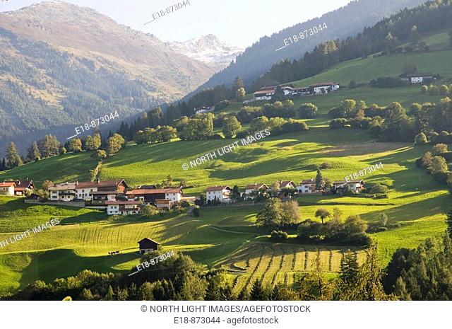 Austria, Tyrol.  Morning light on picturesque farm fields and village near Highway 182 north of Brenner