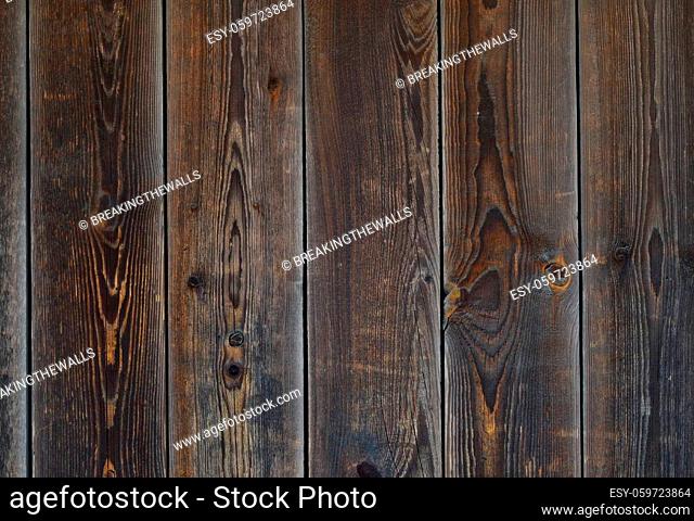 Close up background texture of vintage weathered brown wooden planks with knots and stains