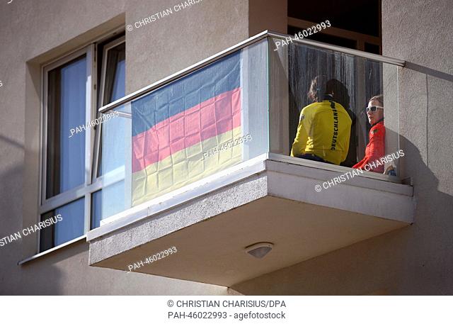 Speed skater Gabriele Hirschbichler and Jenny Wolf of Germany enjoy the sun on the balcony in the Coastal Olympic Village in the Olympic Park in Sochi, Russia