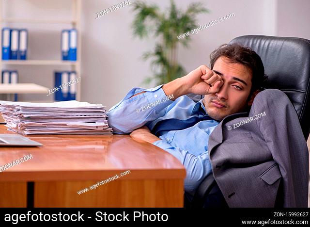 Young employee sleeping in the office