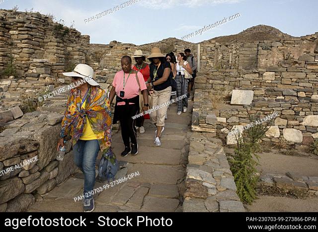 15 June 2023, Greece, Insel Delos: Tourists visit the archaeological site of Delos Island, near Mykonos. Delos is one of the most important mythological