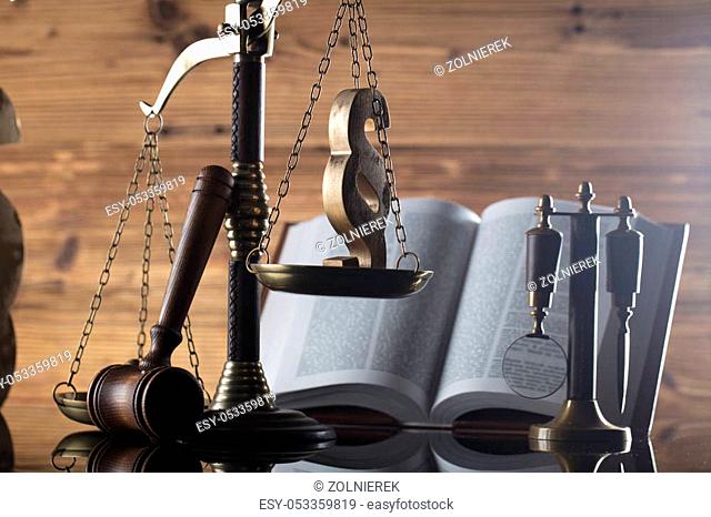 Law symbols. Judge wooden gavel, books and scale. Place for typography