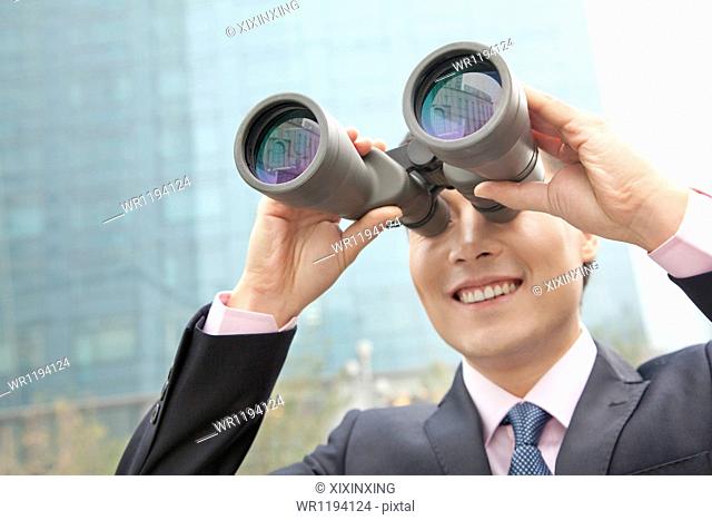 Smiling Businessman Using Binoculars, Reflection