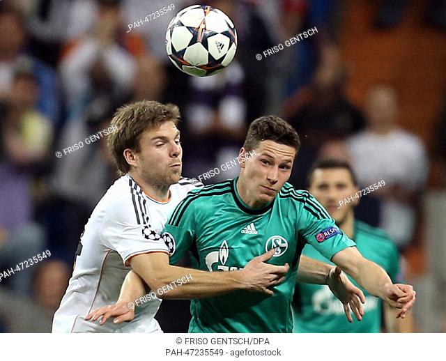 Real Madrid's Asier Illarramendi (L) and Julian Draxler (R) of Schalke vie for the ball during during the Champions League round of 16 second leg soccer match...