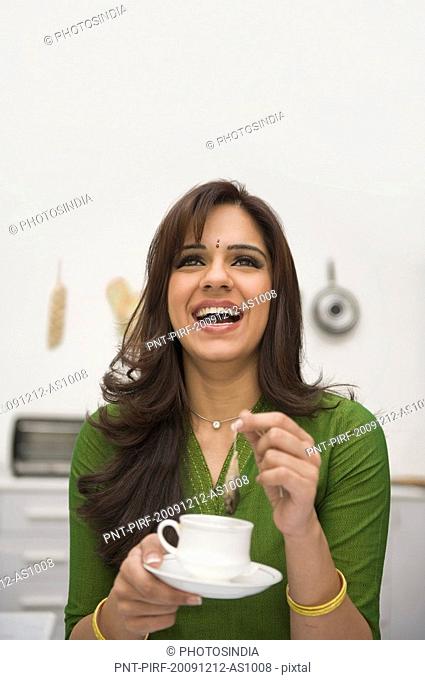 Woman drinking tea and laughing