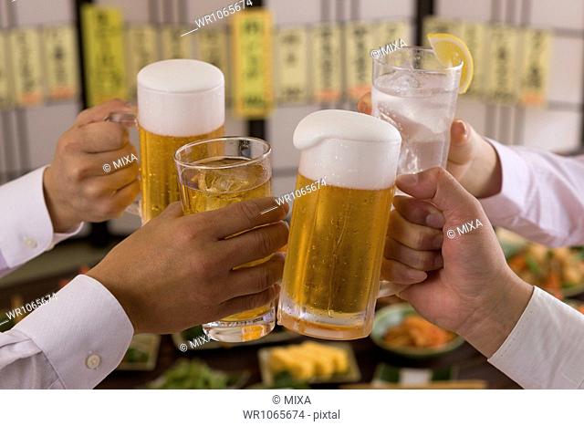 Four People Toasting with Beer and Chu-Hi at Izakaya