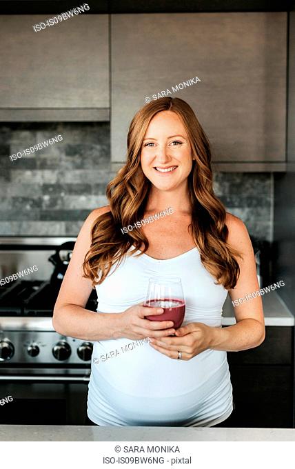 Pregnant woman with glass of smoothie